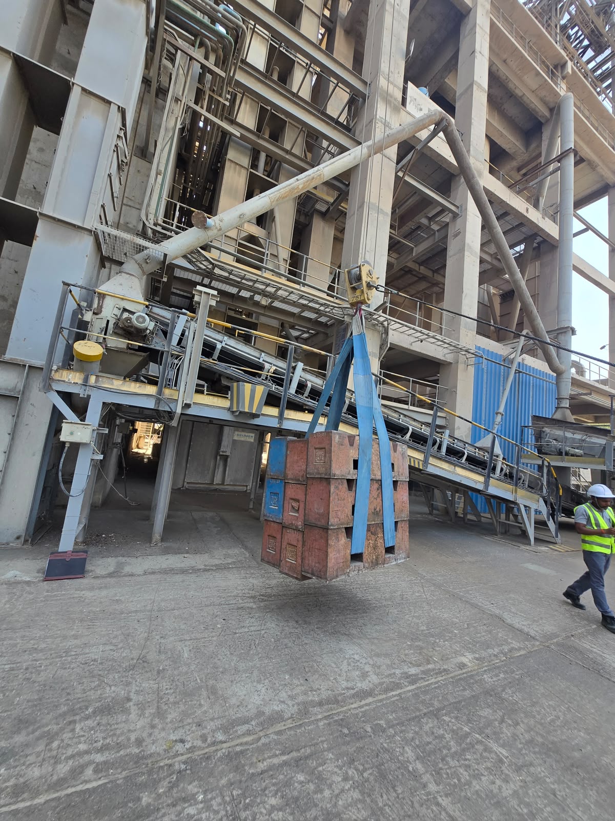 Test weight blocks rigged and lifted on site with a technician for scale